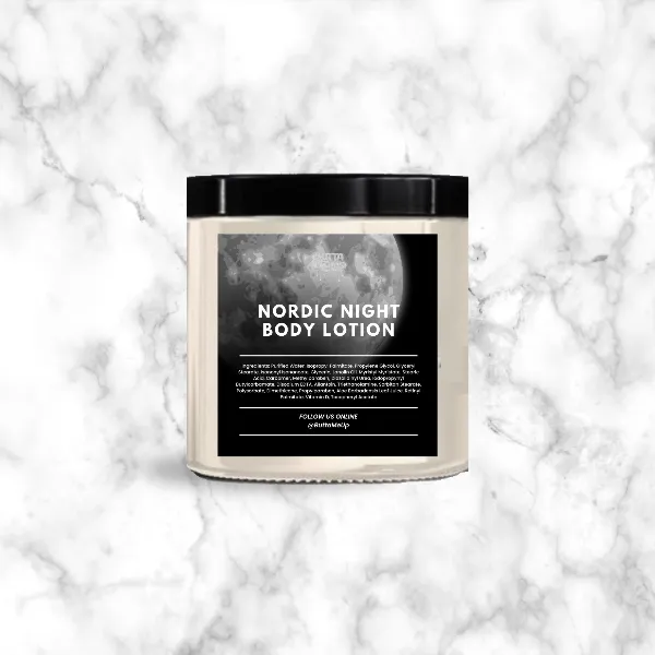 A body lotion jar with a moonlit label reading Nordic Night Body Lotion, on white marble.