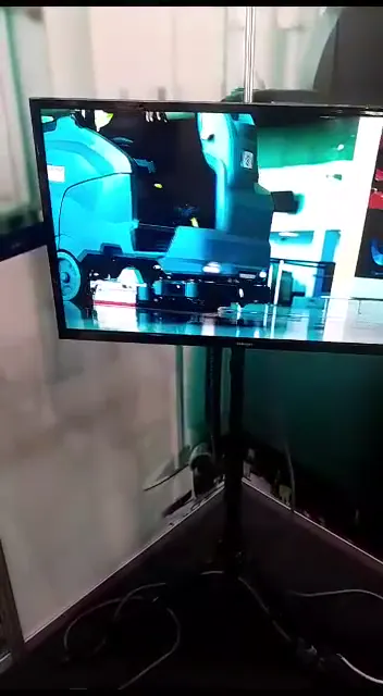 A Milestone Environmental cleaning and disinfection brand video playing on a display screen at an airport.