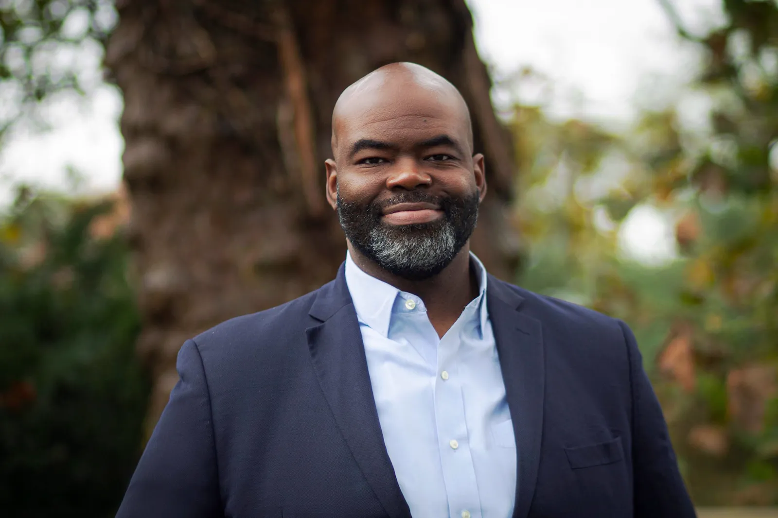 Outdoor business headshot in a navy blazer